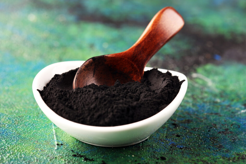 Activated charcoal powder on table for beauty treatment
